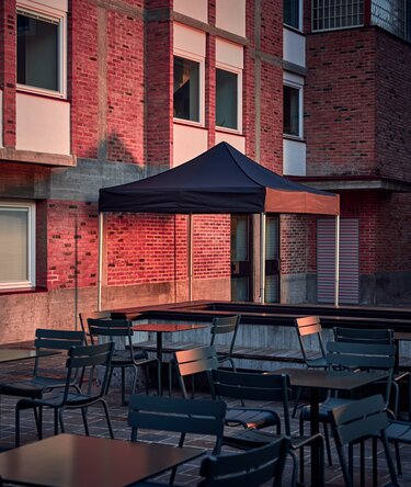 The black 3x3 m folding gazebo serves as an outdoor shelter on the terrace.