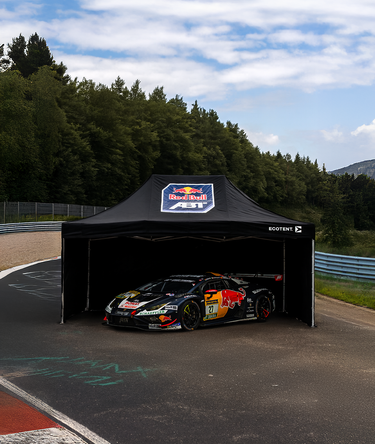 Close-up of a custom-printed Ecotent E1 pop-up gazebo, measuring 4.5 × 3 metres, at a motor race.